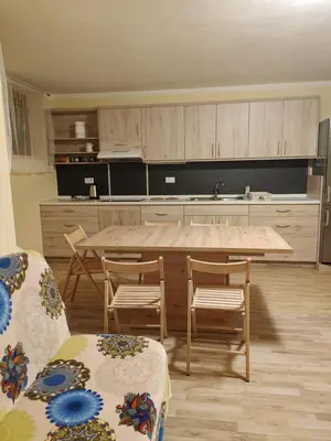 a kitchen with a large wooden table and chairs at Apartma svizec in Bled