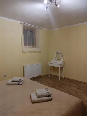 a bedroom with a bed and a table with a mirror at Apartma svizec in Bled