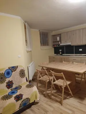a kitchen with a table and chairs in a room at Apartma svizec in Bled