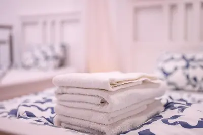 a stack of towels sitting on top of a table at The Modern Loft in Ljubljana