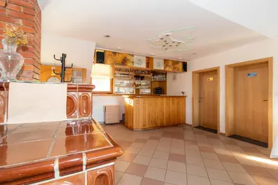 a large kitchen with wooden cabinets and a tile floor at Apartments PIT Zdole in Kozje