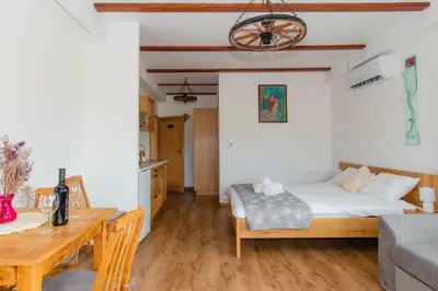 a bedroom with a bed and a wooden table at Apartments PIT Zdole in Kozje