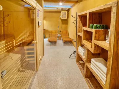 a room with wooden walls and a hallway with chairs at Hiša Zdravega Oddiha in Begunje pri Cerknici