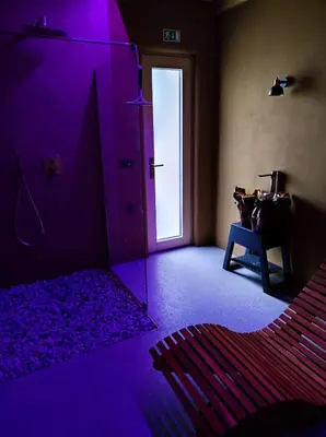 a room with a purple room with a door and a table at Hiša Zdravega Oddiha in Begunje pri Cerknici