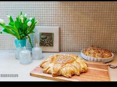 a table with a cake and a plate of food at Vineyard Cottage Klemencic in Novo Mesto