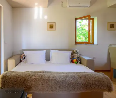 a bedroom with a bed with stuffed animals on it at Vineyard Cottage Klemencic in Novo Mesto