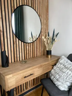 a mirror on top of a wooden table with a chair at Luxury Wide View Apartment Pohorje Bellevue in Pohorje