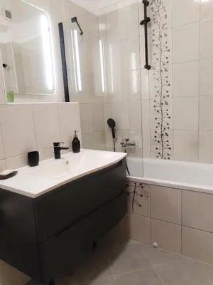 a bathroom with a sink and a bath tub at Luxury Wide View Apartment Pohorje Bellevue in Pohorje