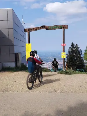 a person riding a bike in front of a sign at Luxury Wide View Apartment Pohorje Bellevue in Pohorje
