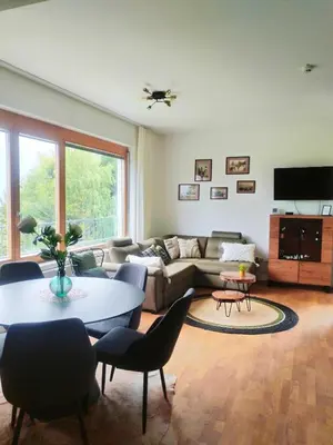 a living room with a couch and a table at Luxury Wide View Apartment Pohorje Bellevue in Pohorje