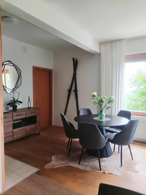 a dining room with a table and chairs at Luxury Wide View Apartment Pohorje Bellevue in Pohorje