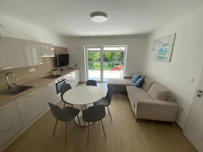 a living room with a couch and a table and chairs at VILA ADA - 4 Cosy Apartments in Ljubljana