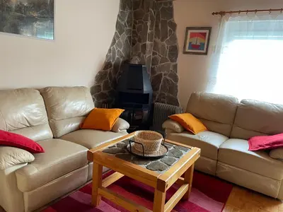a living room with two couches and a coffee table at Vintage Holiday House in Šoštanj