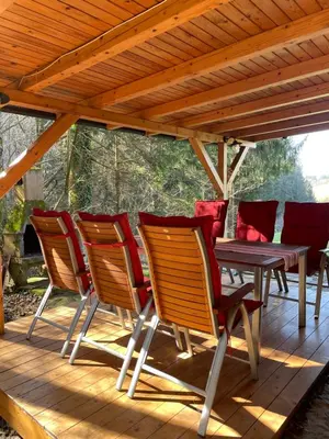 a group of chairs and a table on a deck at Vintage Holiday House in Šoštanj