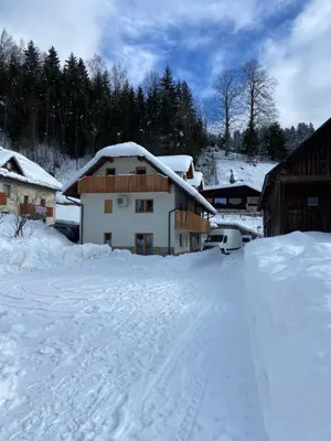 a snow covered building with a lot of snow at New Apartments Teravila in Rateče