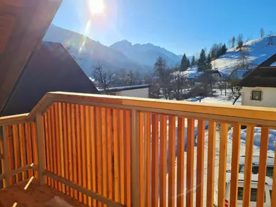 a wooden balcony with a view of the mountains at New Apartments Teravila in Rateče