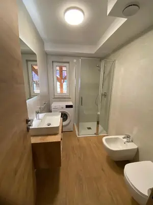 a bathroom with a toilet and a sink and a shower at New Apartments Teravila in Rateče