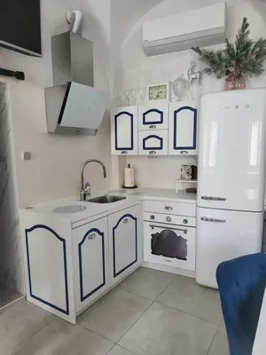 a white kitchen with a sink and a refrigerator at Vintage Apartment In The City Centre Old Town in Ljubljana