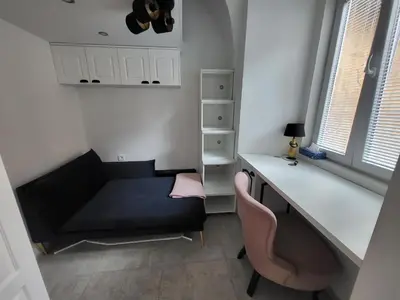 a living room with a desk and a chair at Vintage Apartment In The City Centre Old Town in Ljubljana