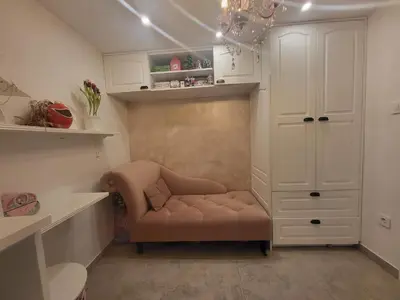 a small room with a chair and a cabinet at Vintage Apartment In The City Centre Old Town in Ljubljana
