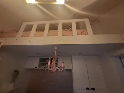 a white bunk bed in a room with a chandelier at Vintage Apartment In The City Centre Old Town in Ljubljana