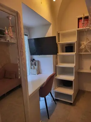 a room with a desk with a computer and shelves at Vintage Apartment In The City Centre Old Town in Ljubljana