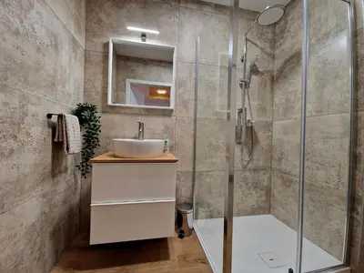 a bathroom with a sink and a shower at Apartment Center Rogaška - Pubyland in Rogaška Slatina