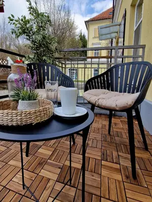 a patio with a table and chairs on a deck at Apartment Center Rogaška - Pubyland in Rogaška Slatina