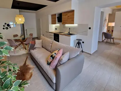 a living room with a couch with pillows at Apartment Center Rogaška - Pubyland in Rogaška Slatina