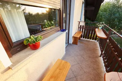 a balcony with a bench and a window at Apartma Steles in Stari Trg pri Ložu