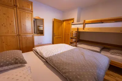 a bedroom with two bunk beds in a room at Bolfenk Snowflake app in Pohorje