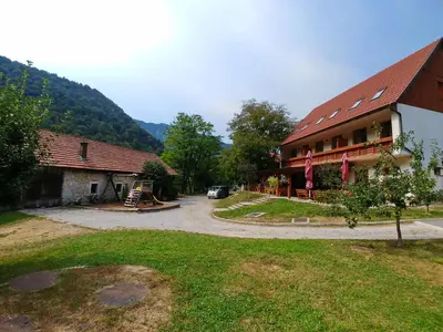 a building with a car parked in front of it at Madronič family estate - Kolpa river in Stari Trg ob Kolpi
