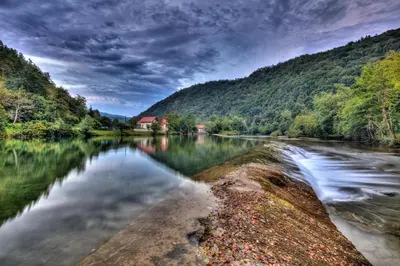 a river in the middle of a forest at Madronič family estate - Kolpa river in Stari Trg ob Kolpi