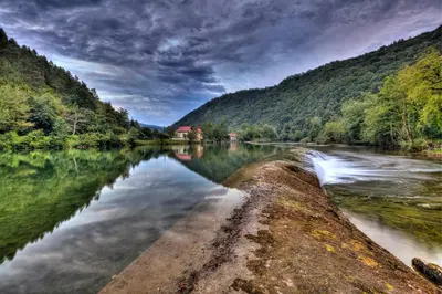a river in the middle of a forest at Madronič family estate - Kolpa river in Stari Trg ob Kolpi