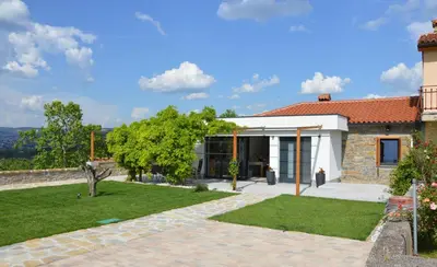 a house with a garden in front of it at Casa Miranda - family comfort in a quiet area, near the sea, with BBQ and FREE parking in Zgornje Škofije