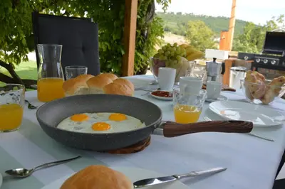 a table with a bowl of eggs and bread on it at Casa Miranda - family comfort in a quiet area, near the sea, with BBQ and FREE parking in Zgornje Škofije