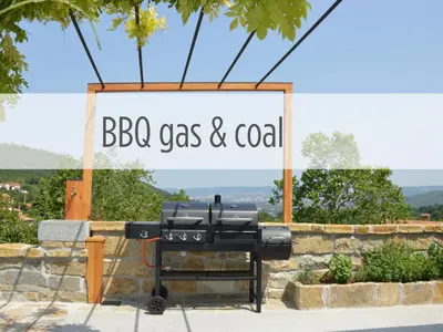 a barbecue grill with a sign that reads bbq gas and coal at Casa Miranda - family comfort in a quiet area, near the sea, with BBQ and FREE parking in Zgornje Škofije