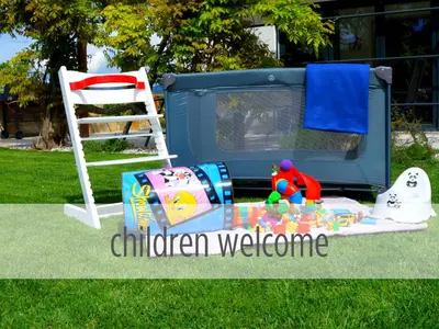 a childs play area with a chair and a television at Casa Miranda - family comfort in a quiet area, near the sea, with BBQ and FREE parking in Zgornje Škofije