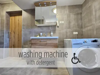a bathroom with a washing machine and a sink at Casa Miranda - family comfort in a quiet area, near the sea, with BBQ and FREE parking in Zgornje Škofije