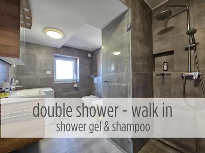 a bathroom with a shower walk in shower gel and shampoo at Casa Miranda - family comfort in a quiet area, near the sea, with BBQ and FREE parking in Zgornje Škofije