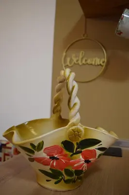 a vase with flowers on it sitting on a table at Apartment Alpina in Pohorje