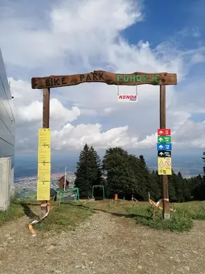 a sign for a bike park in a field at Apartment Alpina in Pohorje