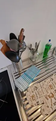 a glass table with utensils on top at Apartman MURKO P-1 in Brest