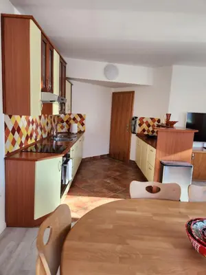 a kitchen with a table and a dining room at Apartma Nika in Planina