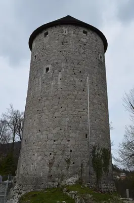 a tall stone tower with a dome on top at Apartma Nika in Planina
