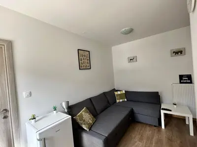a living room with a couch and a table at APARTMA ALMA in Bovec