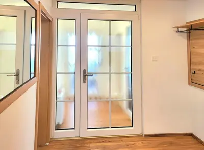 a sliding glass door in a room with a staircase at Bella Bela Apartments 23 in Bled