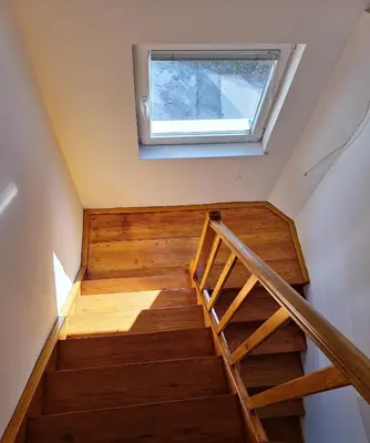 a staircase in a house with a window at Bella Bela Apartments 23 in Bled
