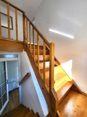 a wooden staircase in a house with wooden floors at Bella Bela Apartments 23 in Bled