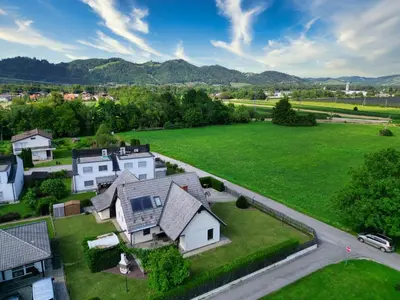 an aerial view of a house with a large green field at Villa Vili - Jacuzzi, BBQ & EV Outlet in Limbuš